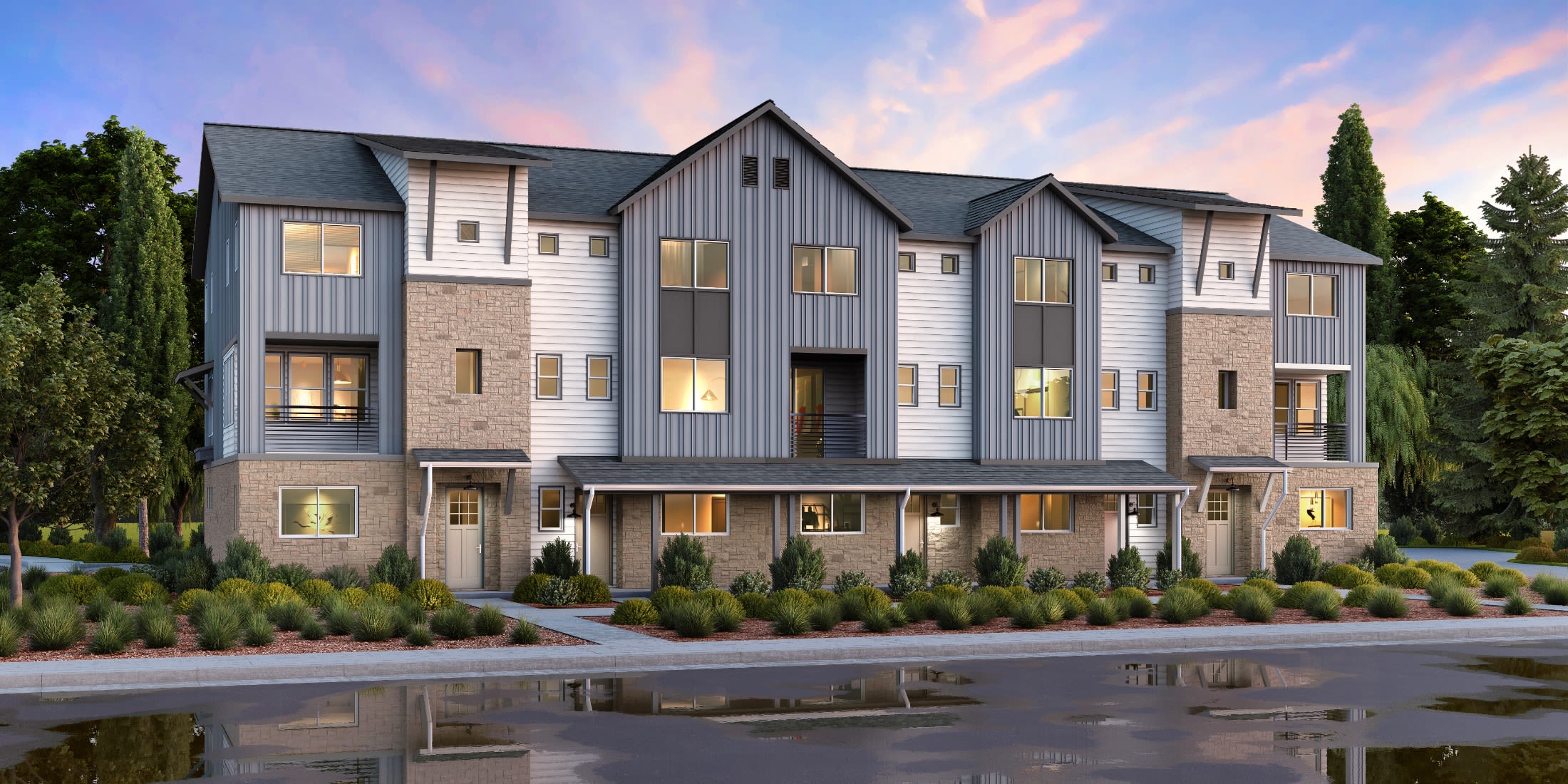 Contemporary build-to-rent townhome buildings at dusk with landscaped walkways